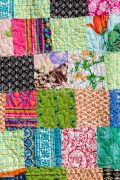 Detail colorful patchwork blanket in India. Close up