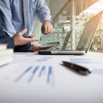 Business adviser analyzing financial figures denoting the progress in the work of the company.
